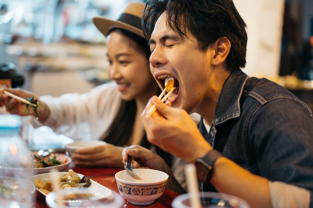 A couple enjoying food at a restaurant in Patong, Phuket