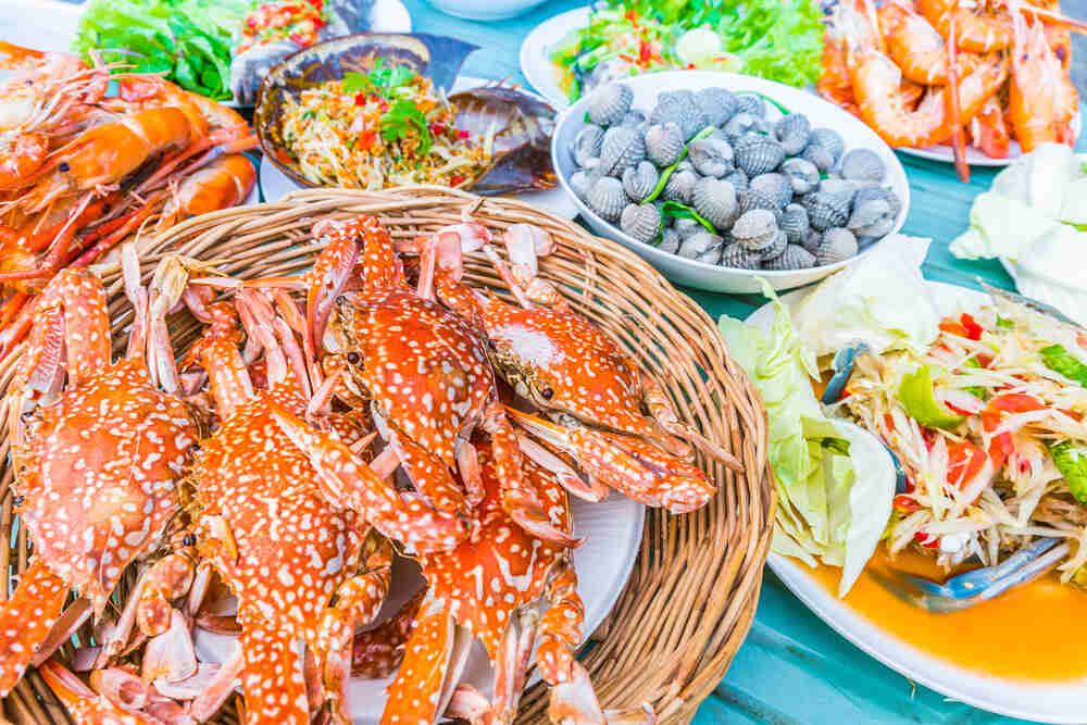 a table with plates full of Thai seafood