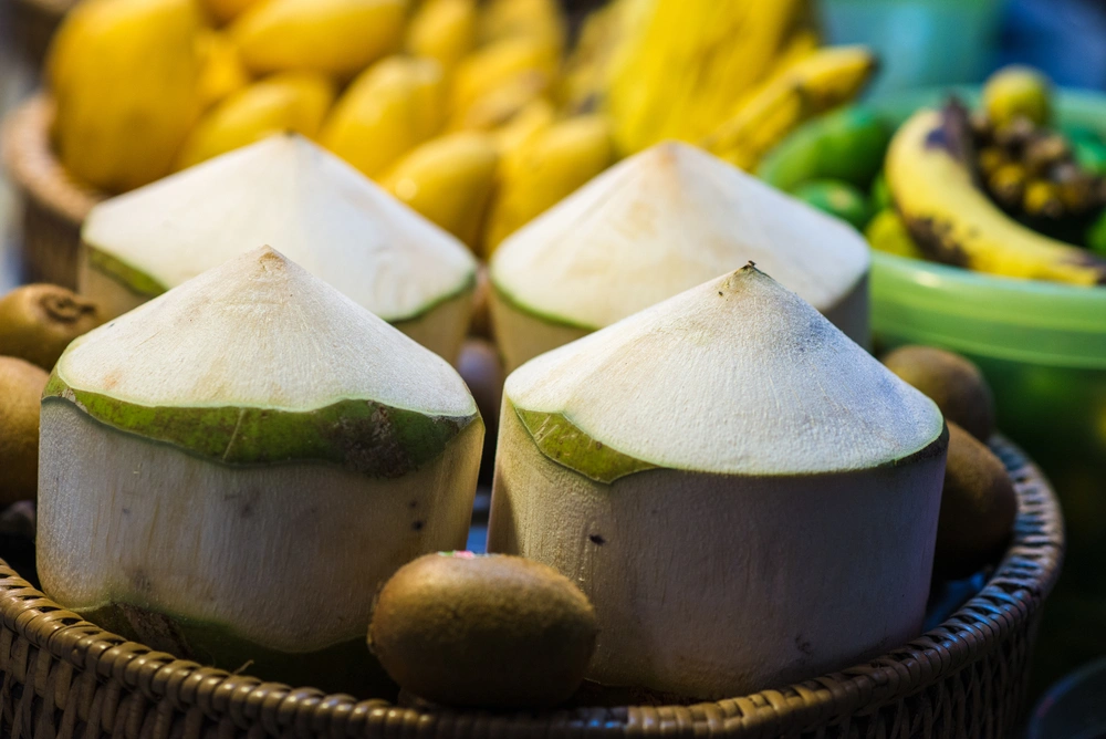 Fresh coconut and various fruits for sale