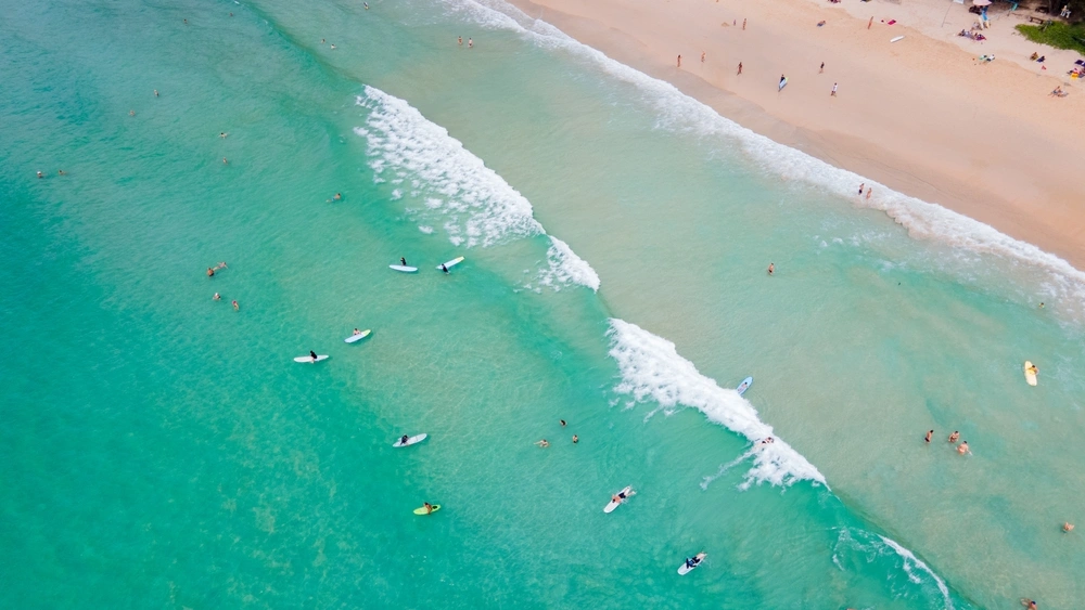 Two friends surfing in Phuket, Thailand