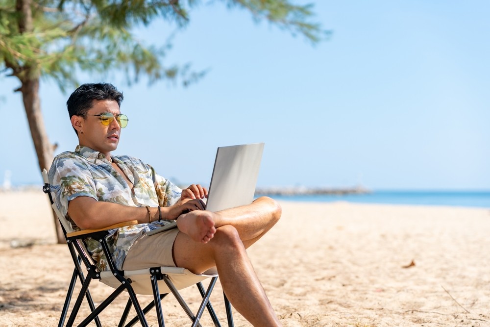 A man working remotely on a Phuket beach
