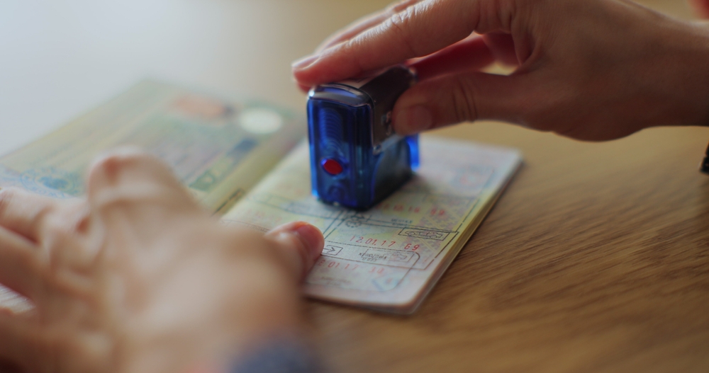 A person putting a stamp on a passport